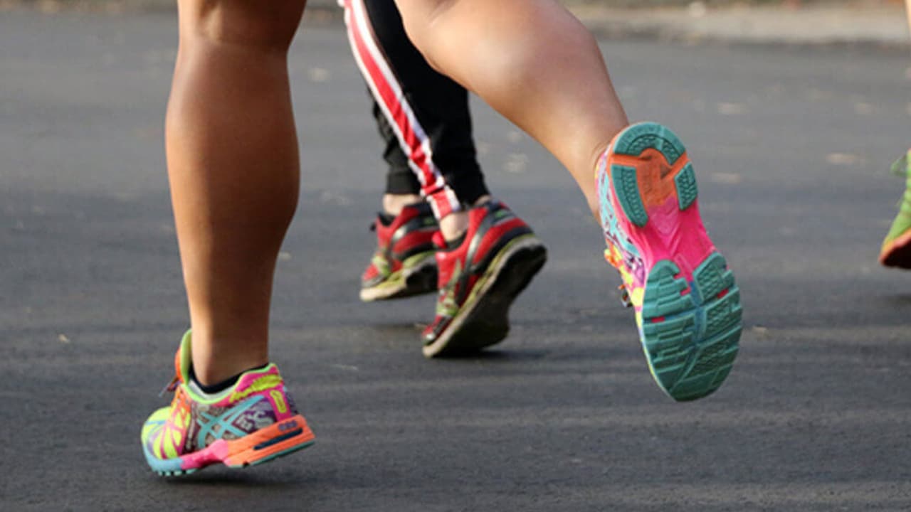 Two runners feet with colorful running shoes