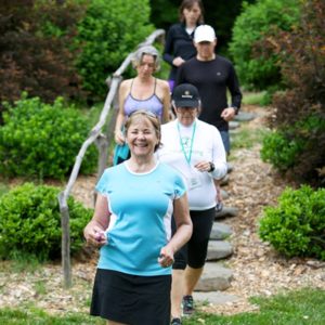 Group of older women and men ChiWalking on outdoor trail