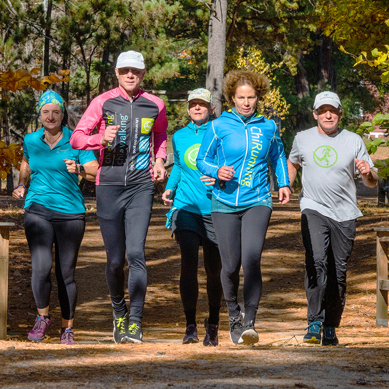 group of adult men and women running using the ChiRunning technique