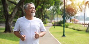 older asian man chiwalking on a rec path